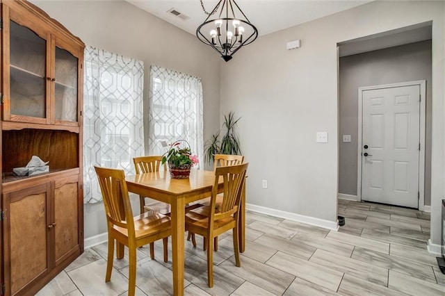 311 S 3rd St, Odessa, MO 64076 - dining space with a chandelier and baseboards