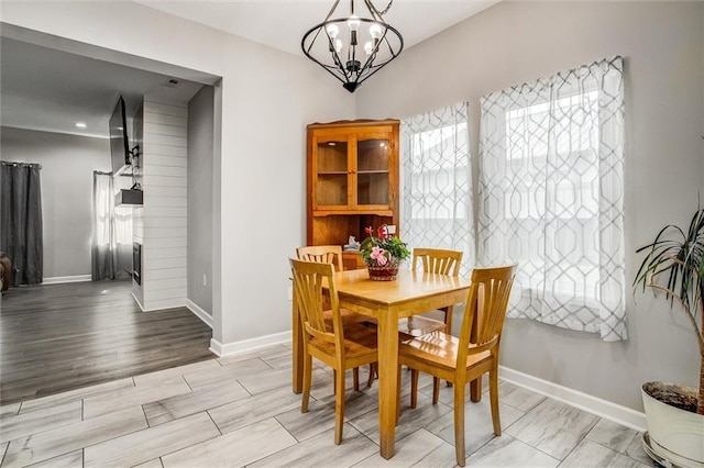 311 S 3rd St, Odessa, MO 64076 - dining space featuring a chandelier and light wood-type flooring
