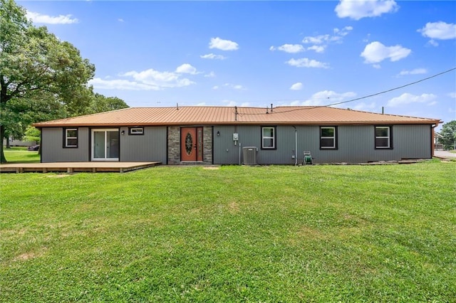 812 W Royle St, Richmond, MO 64085 - rear view of house featuring a lawn, a wooden deck, and a metal roof