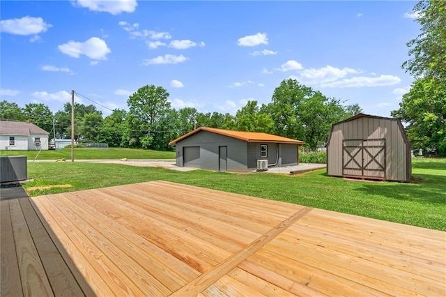 812 W Royle St, Richmond, MO 64085 - wooden terrace featuring a garage, a lawn, view of scattered trees, and a shed
