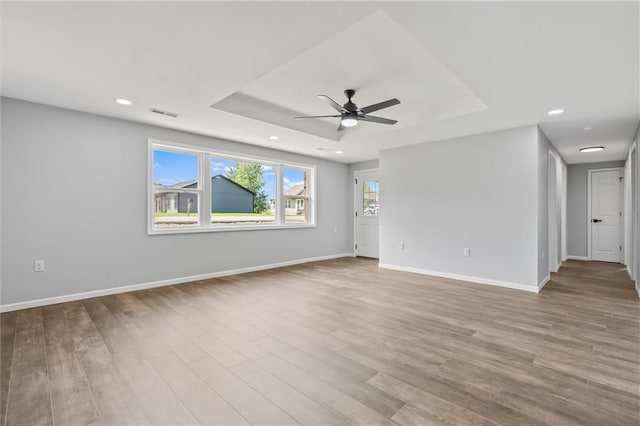 812 W Royle St, Richmond, MO 64085 - spare room with a raised ceiling, ceiling fan, wood finished floors, and recessed lighting