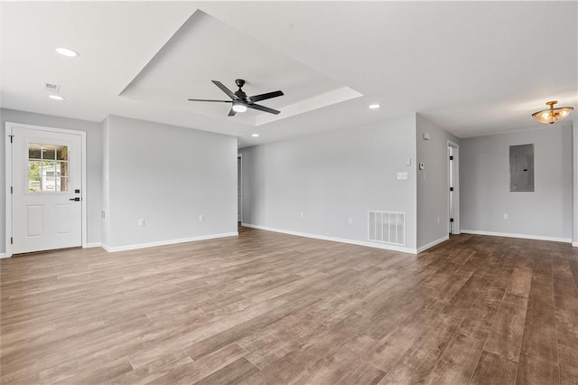 812 W Royle St, Richmond, MO 64085 - unfurnished living room with electric panel, ceiling fan, a raised ceiling, recessed lighting, and wood finished floors