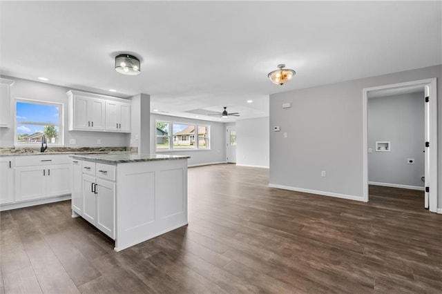 812 W Royle St, Richmond, MO 64085 - kitchen with a ceiling fan, dark wood-type flooring, white cabinetry, open floor plan, and a kitchen island