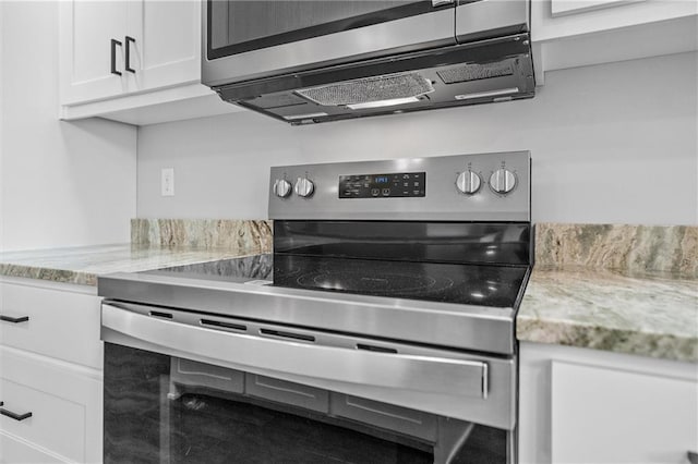 812 W Royle St, Richmond, MO 64085 - kitchen featuring appliances with stainless steel finishes, white cabinetry, and light stone counters