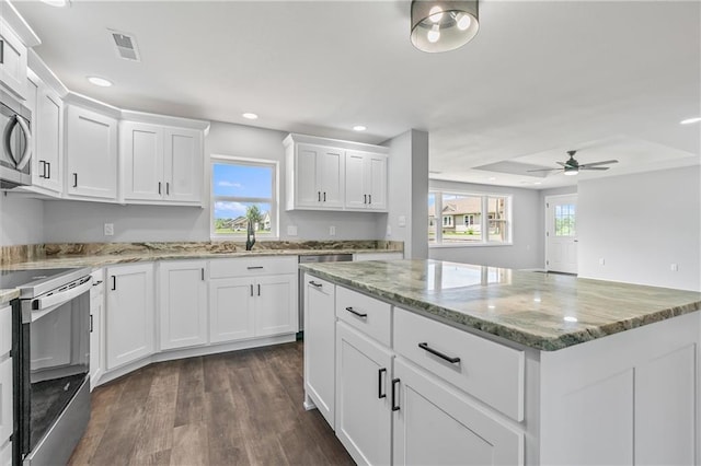 812 W Royle St, Richmond, MO 64085 - kitchen with range with electric cooktop, recessed lighting, white cabinets, a kitchen island, and dark wood-style flooring
