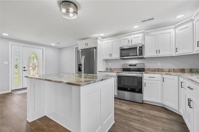 812 W Royle St, Richmond, MO 64085 - kitchen featuring stainless steel appliances, a center island, white cabinets, dark wood-style flooring, and recessed lighting