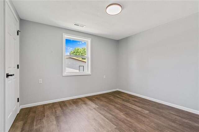 812 W Royle St, Richmond, MO 64085 - unfurnished room featuring wood finished floors and baseboards