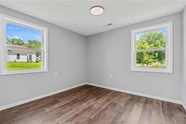 812 W Royle St, Richmond, MO 64085 - spare room featuring plenty of natural light and wood finished floors