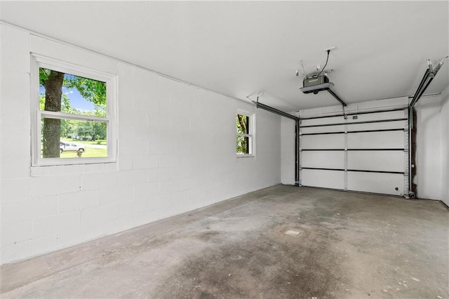 812 W Royle St, Richmond, MO 64085 - garage featuring a garage door opener and concrete block wall