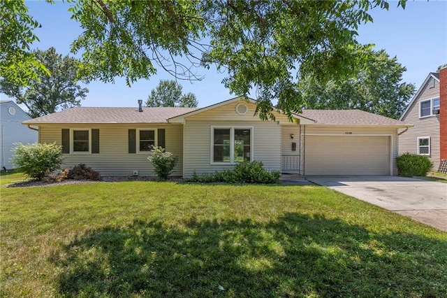 1138 S Willow St, Ottawa, KS 66067 - ranch-style house with concrete driveway, an attached garage, a front yard, and a shingled roof