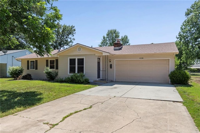 1138 S Willow St, Ottawa, KS 66067 - ranch-style home featuring a garage, driveway, a front yard, and a chimney