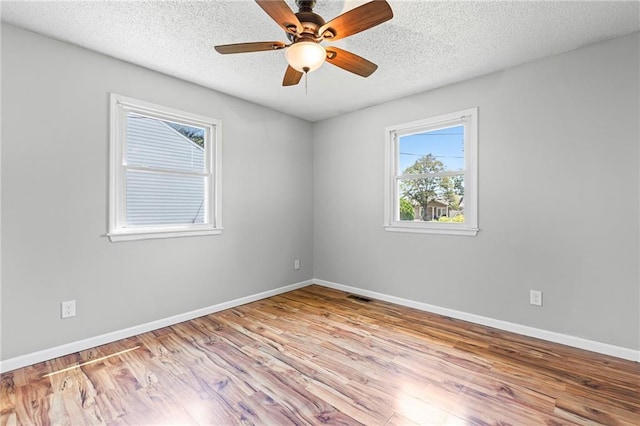 1138 S Willow St, Ottawa, KS 66067 - empty room featuring wood finished floors, a textured ceiling, and ceiling fan