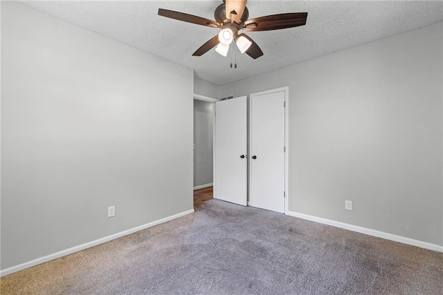 1138 S Willow St, Ottawa, KS 66067 - unfurnished bedroom with a textured ceiling, carpet flooring, and a ceiling fan