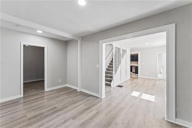 4320 E 43rd St, Kansas City, MO 64130 - empty room with stairs, wood finished floors, and recessed lighting
