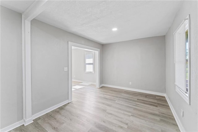4320 E 43rd St, Kansas City, MO 64130 - empty room with light wood-style flooring and a textured ceiling