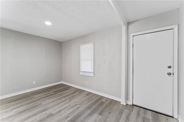4320 E 43rd St, Kansas City, MO 64130 - foyer entrance with wood finished floors, recessed lighting, and a textured ceiling