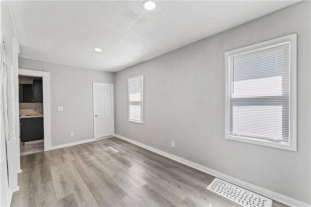 4320 E 43rd St, Kansas City, MO 64130 - unfurnished bedroom with wood finished floors and recessed lighting