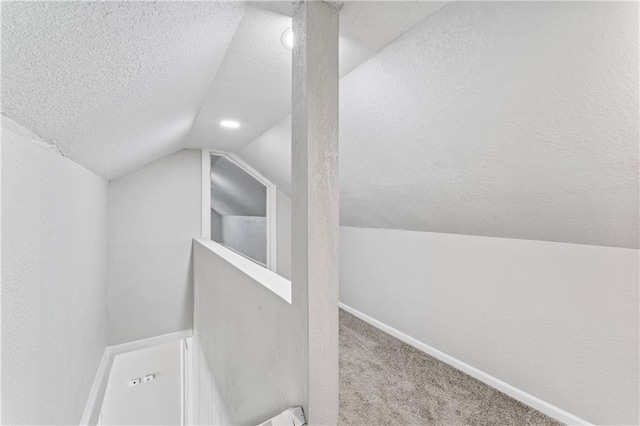 4320 E 43rd St, Kansas City, MO 64130 - additional living space featuring a textured ceiling, vaulted ceiling, carpet flooring, and recessed lighting