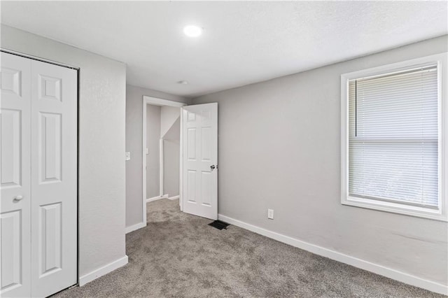 4320 E 43rd St, Kansas City, MO 64130 - unfurnished bedroom featuring carpet floors and a closet