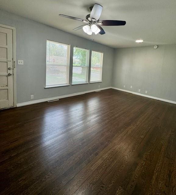 6300 E 149th St, Grandview, MO 64030 - spare room with dark wood finished floors and a ceiling fan
