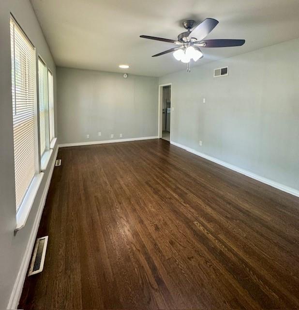 6300 E 149th St, Grandview, MO 64030 - spare room featuring dark wood finished floors and ceiling fan