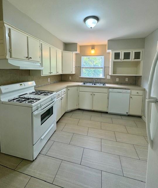 6300 E 149th St, Grandview, MO 64030 - kitchen featuring white appliances, under cabinet range hood, backsplash, and white cabinetry