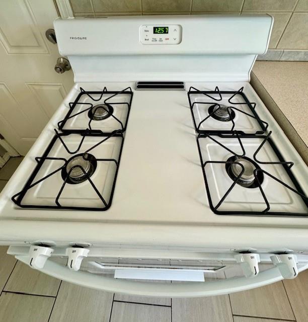6300 E 149th St, Grandview, MO 64030 - kitchen view of white gas range oven and light countertops