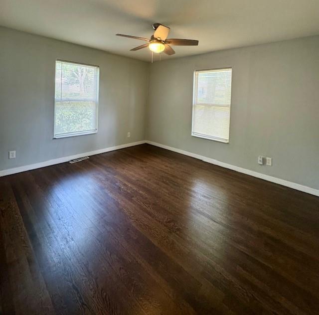6300 E 149th St, Grandview, MO 64030 - empty room with wood finished floors and ceiling fan