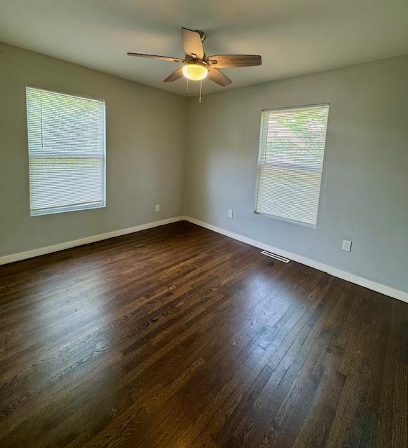 6300 E 149th St, Grandview, MO 64030 - unfurnished room with dark wood-style flooring and a ceiling fan