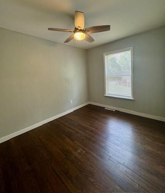 6300 E 149th St, Grandview, MO 64030 - spare room with dark wood-type flooring and ceiling fan