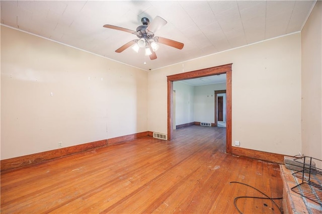 919 Indiana St, Neodesha, KS 66757 - empty room featuring light wood-style floors, crown molding, and ceiling fan