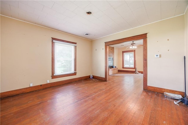 919 Indiana St, Neodesha, KS 66757 - empty room with ornamental molding, hardwood / wood-style floors, and a ceiling fan