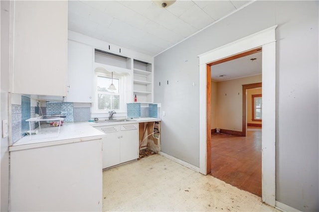 919 Indiana St, Neodesha, KS 66757 - kitchen featuring light flooring, light countertops, white cabinets, open shelves, and backsplash