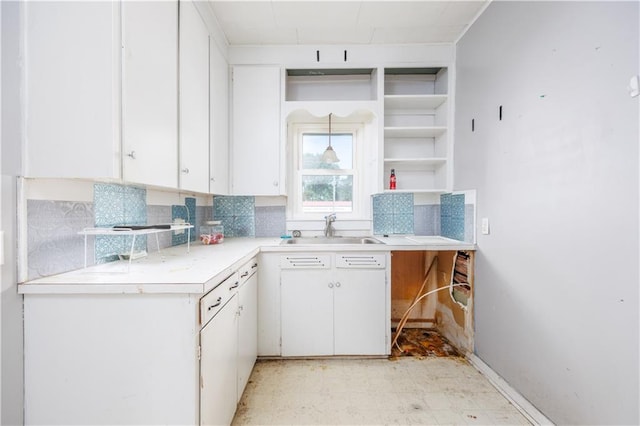 919 Indiana St, Neodesha, KS 66757 - kitchen with light floors, tasteful backsplash, open shelves, and white cabinets