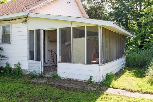 919 Indiana St, Neodesha, KS 66757 - view of property exterior with a sunroom and roof with shingles