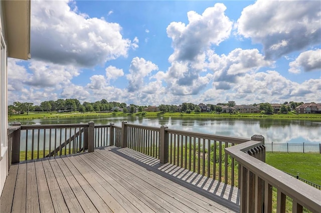 129 SE Chelsea Dr, Lees Summit, MO 64063 - wooden terrace with a water view and a fenced backyard