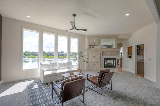129 SE Chelsea Dr, Lees Summit, MO 64063 - living room with light colored carpet, ceiling fan, plenty of natural light, and recessed lighting