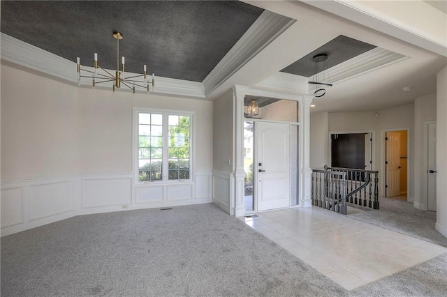 129 SE Chelsea Dr, Lees Summit, MO 64063 - foyer entrance featuring a tray ceiling, carpet floors, crown molding, a chandelier, and a decorative wall