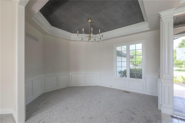 129 SE Chelsea Dr, Lees Summit, MO 64063 - unfurnished dining area featuring a tray ceiling, a chandelier, healthy amount of natural light, carpet, and wainscoting
