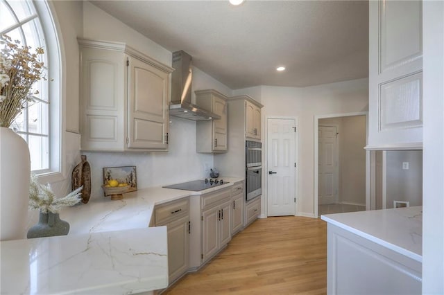129 SE Chelsea Dr, Lees Summit, MO 64063 - kitchen with wall chimney range hood, light wood-style floors, tasteful backsplash, recessed lighting, and light stone counters