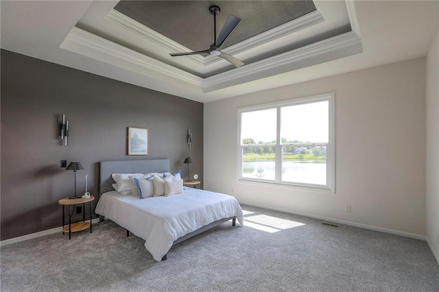 129 SE Chelsea Dr, Lees Summit, MO 64063 - carpeted bedroom featuring a tray ceiling, ornamental molding, and a ceiling fan