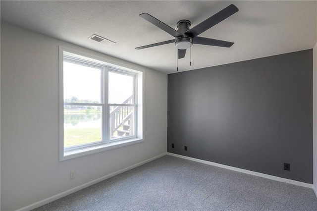 129 SE Chelsea Dr, Lees Summit, MO 64063 - spare room featuring ceiling fan, carpet flooring, and a textured ceiling