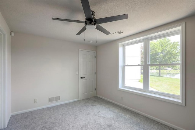 129 SE Chelsea Dr, Lees Summit, MO 64063 - spare room with carpet flooring, a textured ceiling, and ceiling fan