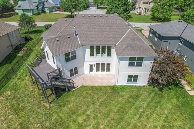 129 SE Chelsea Dr, Lees Summit, MO 64063 - rear view of property with a shingled roof, a residential view, and a deck