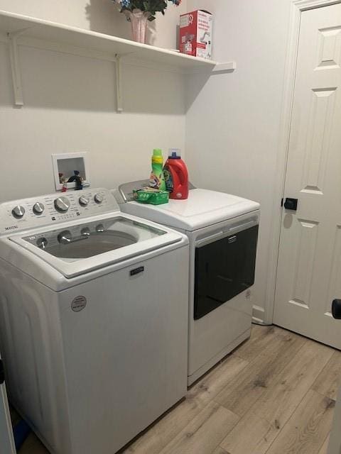 211 Harrison St, Pomona, KS 66076 - washroom with washer and dryer and light wood finished floors