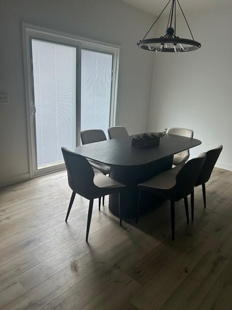 211 Harrison St, Pomona, KS 66076 - dining area with wood finished floors and a chandelier