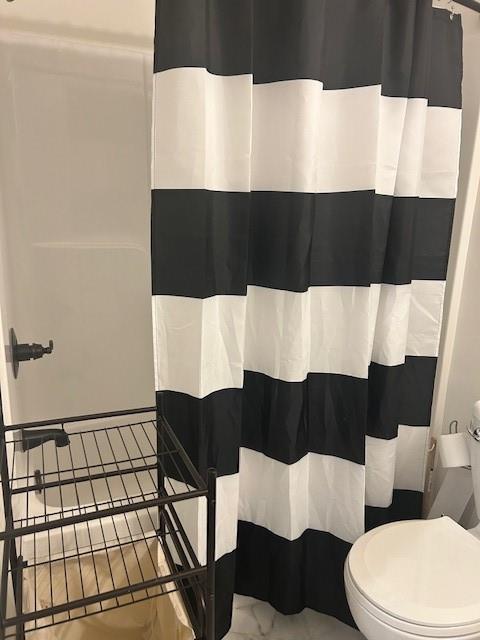 211 Harrison St, Pomona, KS 66076 - bathroom with curtained shower and marble finish floors