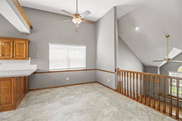 3605 NW Pier Ct, Blue Springs, MO 64015 - kitchen featuring a ceiling fan, brown cabinets, light colored carpet, and high vaulted ceiling