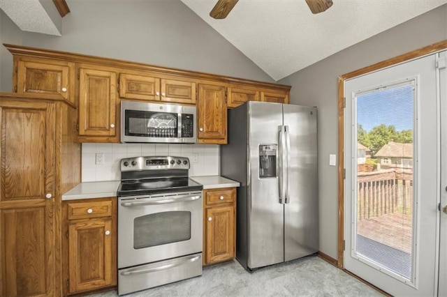 3605 NW Pier Ct, Blue Springs, MO 64015 - kitchen featuring stainless steel appliances, ceiling fan, brown cabinets, light countertops, and lofted ceiling