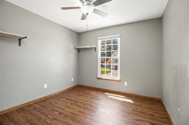 3605 NW Pier Ct, Blue Springs, MO 64015 - spare room with wood finished floors, ceiling fan, and a textured ceiling